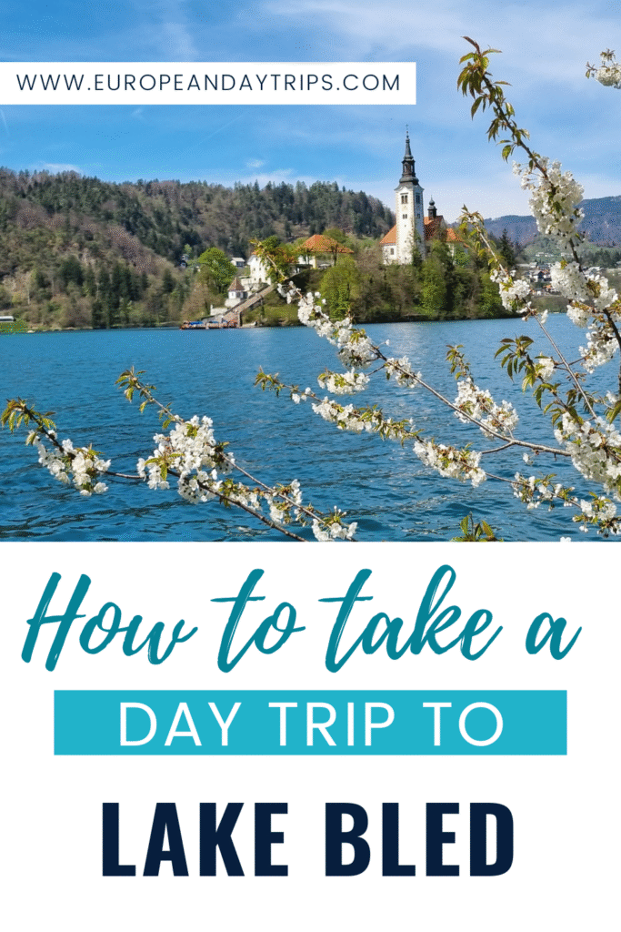A promotional graphic for a blog post titled "How to Take a Day Trip to Lake Bled" from EuropeAndDayTrips.com. The image shows the iconic Church of the Assumption on Bled Island framed by blooming spring cherry blossoms over Lake Bled.