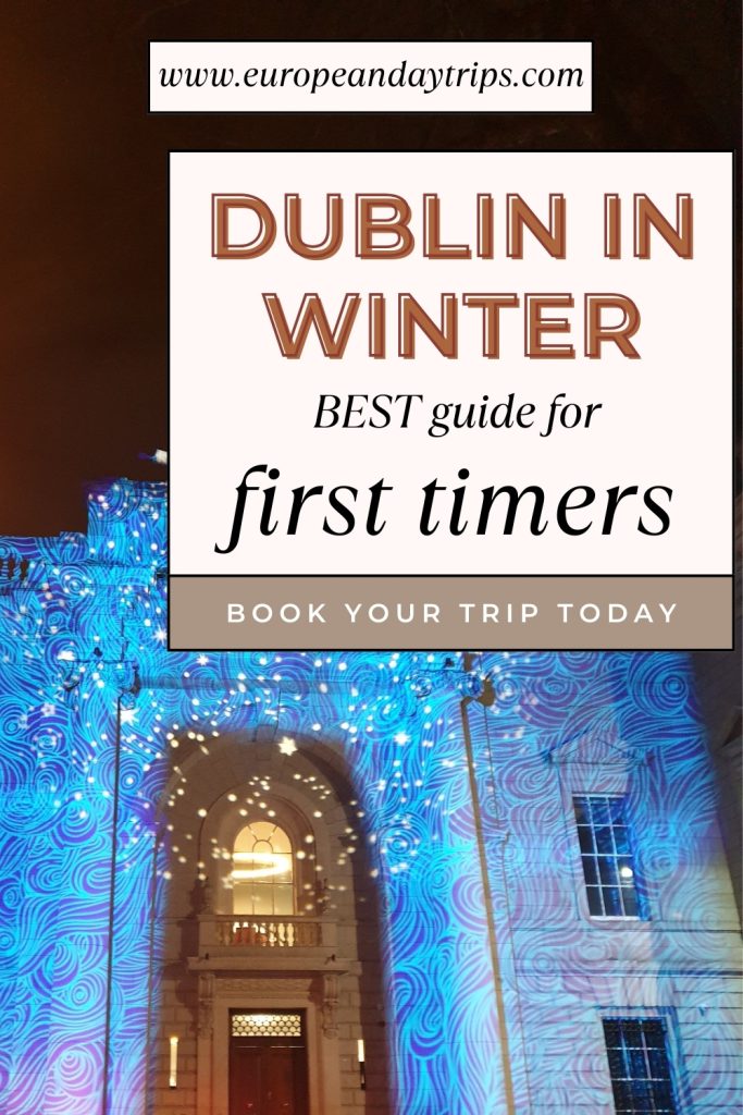 Historic Dublin building illuminated with swirling blue winter light projections under a night sky. Text overlay promotes “Dublin in Winter – Best guide for first timers” from europeandaytrips.com.