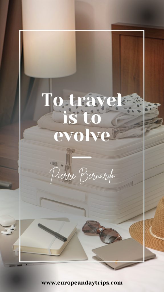 White suitcase on a bed in a hotel room with folded clothes on top. A notebook, pen, sunglasses, hat, earbuds, and laptop are arranged in the foreground beside a lamp and wooden headboard. Overlaid text reads "To travel is to evolve" and "Pierre Bernardo" and europeandaytrips.com